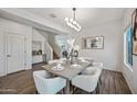 Formal dining area with modern lighting, a gray dining table, and seating for six at 2776 E Mews Rd, Gilbert, AZ 85298