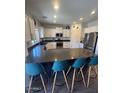 Spacious kitchen with ample counter seating, stainless steel appliances, and plenty of cabinet storage at 2776 E Mews Rd, Gilbert, AZ 85298