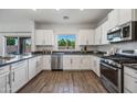Bright kitchen with stainless steel appliances, light wood floors, and ample counter space at 2776 E Mews Rd, Gilbert, AZ 85298