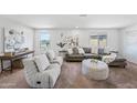 Spacious living room with plush seating, carpeted floors, and plenty of natural light at 2776 E Mews Rd, Gilbert, AZ 85298