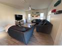 Bright living room with a large sectional sofa and tile flooring at 2776 E Mews Rd, Gilbert, AZ 85298