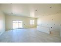 Spacious, bright room with large sliding glass doors and modern tile flooring at 28583 N 257Th Dr, Wittmann, AZ 85361