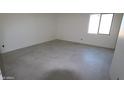Bright bedroom with a window and tile flooring at 28615 N 257Th Dr, Wittmann, AZ 85361
