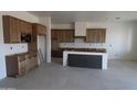 Spacious kitchen with custom wood cabinets and a large center island at 28615 N 257Th Dr, Wittmann, AZ 85361