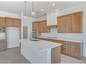 Bright kitchen featuring shaker cabinets, quartz countertops, and stainless steel appliances at 28615 N 257Th Dr, Wittmann, AZ 85361
