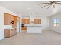 Bright kitchen with shaker cabinets, quartz countertops, and stainless steel appliances at 28615 N 257Th Dr, Wittmann, AZ 85361