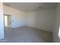 Spacious living room with tile flooring and a large window at 28615 N 257Th Dr, Wittmann, AZ 85361