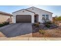 One-story home with brown garage door and landscaped yard at 3341 E Rebel Ln, San Tan Valley, AZ 85143