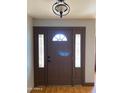 Front entry with a dark brown door and sidelights at 3506 W Yucca St, Phoenix, AZ 85029