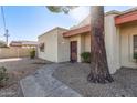 Front entrance of condo with walkway and mature tree at 3535 W Monte Cristo Ave # 101, Phoenix, AZ 85053