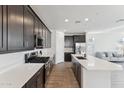 Contemporary kitchen with stainless steel appliances and island overlooking the living area at 4342 E Enmark Dr, San Tan Valley, AZ 85143