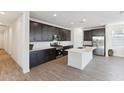 Modern kitchen with stainless steel appliances, dark cabinets, and a bright white island at 4342 E Enmark Dr, San Tan Valley, AZ 85143