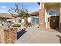 Close up of front entrance with brick column, paved walkway and mature shade tree at 5345 E Mclellan Rd # 89, Mesa, AZ 85205