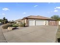 Spacious three-car garage with a long driveway and mature landscaping at 5345 E Mclellan Rd # 89, Mesa, AZ 85205
