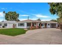 Charming single-story home with manicured lawn, spacious driveway and lovely curb appeal at 545 W Windsor Ave, Phoenix, AZ 85003