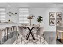 Modern dining area with glass table and four chairs at 6502 N Central Ave # B104, Phoenix, AZ 85012