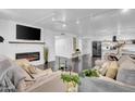 Open concept living room, fireplace, and kitchen view at 6502 N Central Ave # B104, Phoenix, AZ 85012