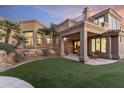 Landscaped backyard with artificial turf and patio at 10102 E Saddle Horn Trl, Scottsdale, AZ 85255