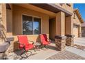 Covered porch with stone columns and comfortable seating at 105 S 224Th Ave, Buckeye, AZ 85326