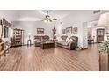 Spacious living room featuring hardwood floors and comfy brown sofas at 12450 W Fieldstone Dr, Sun City West, AZ 85375