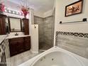 Bathroom features a large soaking tub, walk-in shower, and double vanity at 13602 S Garnet Rd, Buckeye, AZ 85326