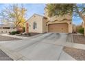 Two-story house with tan exterior, red-tiled accents, and a two-car garage at 13608 N 150Th Ln, Surprise, AZ 85379