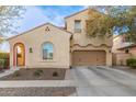 Two-story house with tan exterior, red-tiled accents, and a two-car garage at 13608 N 150Th Ln, Surprise, AZ 85379