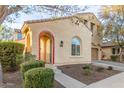 Two-story house with tan exterior, red-tiled accents, and a two-car garage at 13608 N 150Th Ln, Surprise, AZ 85379