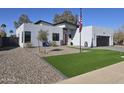 Contemporary house with a red door and artificial turf at 14426 N 39Th Way, Phoenix, AZ 85032