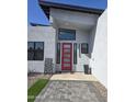 Modern home entrance with a red door and geometric decor at 14426 N 39Th Way, Phoenix, AZ 85032