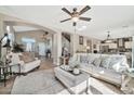 Bright living room with plush sofas and a large TV at 15791 W Mohave St, Goodyear, AZ 85338