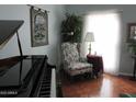 Bright living room with floral armchair and large window at 16809 N Meadow Park Dr, Sun City, AZ 85351