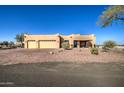 Ranch style home with three car garage and mature trees at 20040 W Hunter Dr, Wittmann, AZ 85361