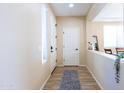 Light-colored entryway with tile flooring, white door, and neutral walls at 20473 W Park Meadows Dr, Buckeye, AZ 85396