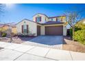 Two-story house with beige exterior, brown garage door, and landscaped front yard at 20473 W Park Meadows Dr, Buckeye, AZ 85396