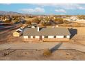 Aerial view of single story home with large yard and mountain views at 22352 W Meade Ln, Buckeye, AZ 85326