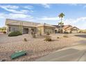 Front view of a one-story house with a gravel yard at 22915 N Wagon Wheel Dr, Sun City West, AZ 85375