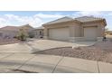 Two-car garage with a curved driveway at 22915 N Wagon Wheel Dr, Sun City West, AZ 85375