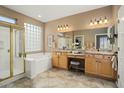 Elegant bathroom with double vanities and a large soaking tub at 23313 N De La Guerra Ct, Sun City West, AZ 85375