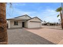 Charming single Gathering home with a brick paver driveway and a white exterior at 2345 W Monroe St # 4, Phoenix, AZ 85009