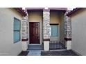 Front entry with a dark brown door and stone pillars at 2471 E Jade Dr, Chandler, AZ 85286