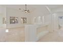 Bright living room with travertine floors, neutral paint, and arched architectural details at 2471 E Jade Dr, Chandler, AZ 85286