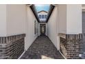 Elegant entryway with a brick walkway leading to a modern front door at 2553 E Virginia Cir, Mesa, AZ 85213