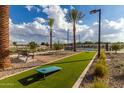 Community area with cornhole, benches, and landscaping at 2607 E Virginia Cir, Mesa, AZ 85213