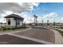 Gated community entrance with guardhouse and paved road at 2607 E Virginia Cir, Mesa, AZ 85213