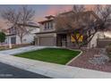 Two-story house with brown garage door and a landscaped front yard at 29405 W Columbus Ave, Buckeye, AZ 85396