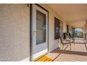 Front door entry and small patio with chairs and table at 3270 S Goldfield Rd # 816, Apache Junction, AZ 85119