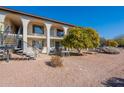 Second exterior view of a two-story building with balconies, landscaping, and a stairway at 3270 S Goldfield Rd # 816, Apache Junction, AZ 85119