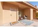 Small front patio with two chairs and a welcome mat at 3511 E Baseline Rd # 1206, Phoenix, AZ 85042