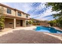 Backyard oasis featuring a sparkling pool, lush landscaping, and a spacious patio area, perfect for outdoor entertaining at 3843 E Old Stone N Cir, Chandler, AZ 85249